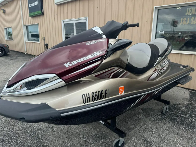Slide: The Image of 2011 Kawasaki Ultra 310LX jet ski in showroom, maroon and gold design. - 3
