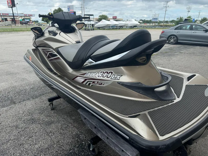 Slide: The Image of 2011 Kawasaki Ultra 310LX jet ski parked outdoors on asphalt. - 4