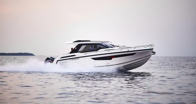 Slide: The Image of 2024 Skamander Sorrento boat cruising on calm water at sunset. - 0