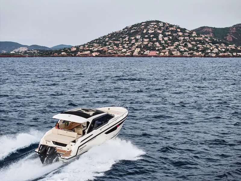 Slide: The Image of 2024 Skamander Sorrento boat cruising on the ocean with scenic hillside backdrop. - 12