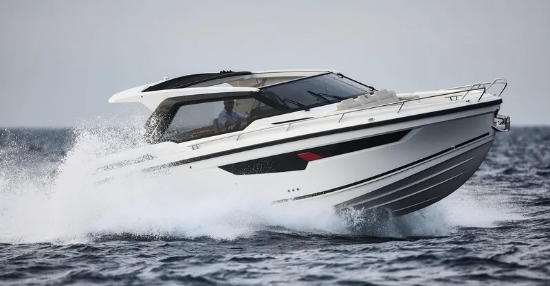 Slide: The Image of 2024 Skamander Sorrento boat cruising on open water, showcasing sleek design and performance. - 14