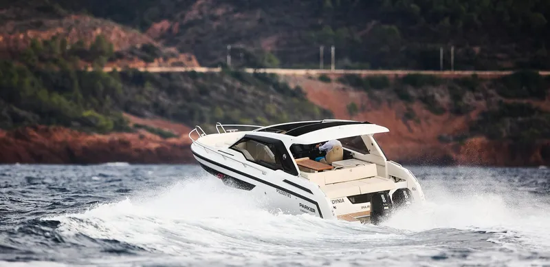 Slide: The Image of 2024 Skamander Sorrento boat navigating through waves near a rocky coastline. - 15