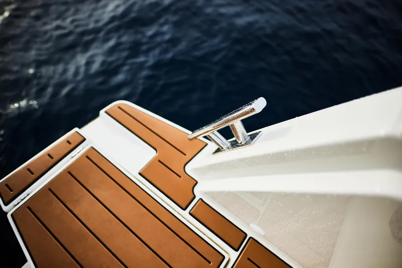 Slide: The Image of 2024 Skamander Sorrento boat deck with teak flooring, overlooking deep blue water. - 18