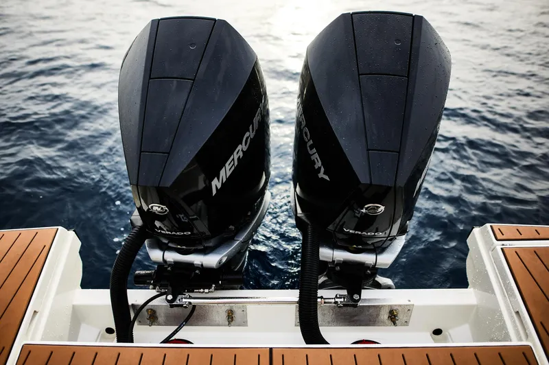 Slide: The Image of Twin Mercury outboard engines on a 2024 Skamander Sorrento boat, viewed from the rear. - 19