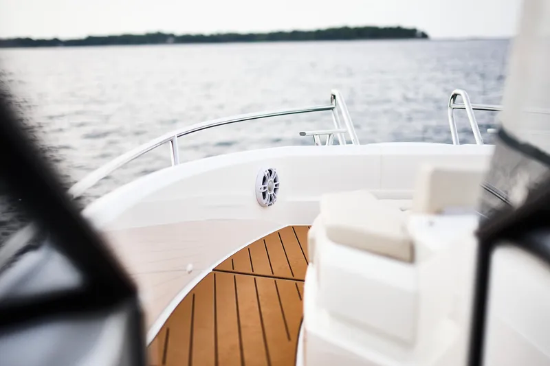 Slide: The Image of 2024 Skamander Sorrento boat deck with wooden flooring, overlooking calm waters. - 25