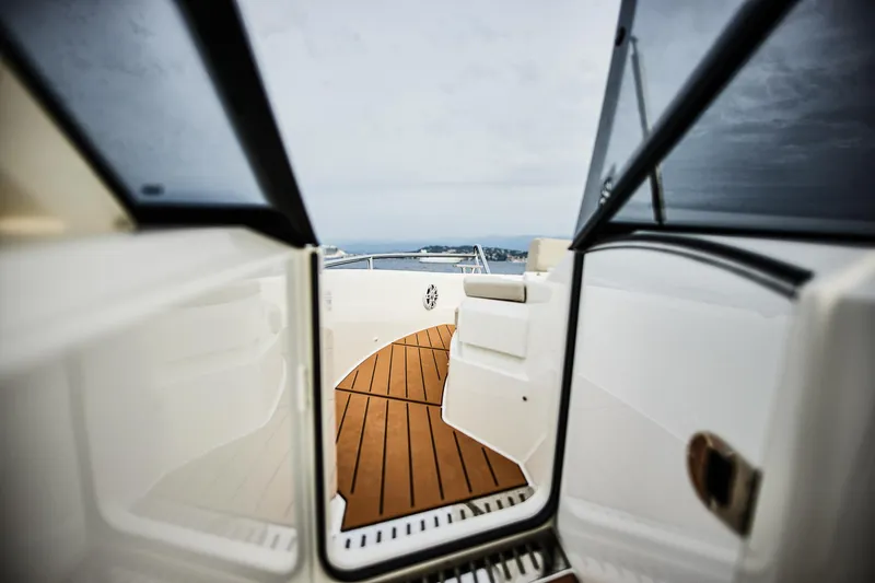 Slide: The Image of 2024 Skamander Sorrento yacht interior with wooden deck and open door view. - 26