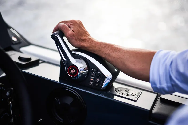Slide: The Image of Hand operating Skamander Sorrento 2024 boat throttle control on sleek dashboard. - 31