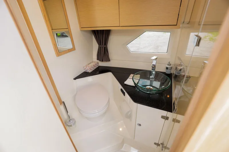 Slide: The Image of 2024 Skamander Sorrento bathroom with modern fixtures, glass sink, and wooden cabinetry. - 41