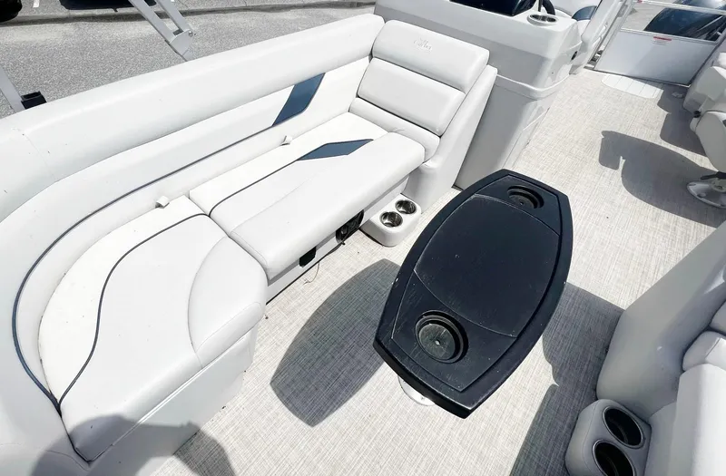 Slide: The Image of 2021 SunCatcher Select 20RC boat interior with white seating and black table. - 3