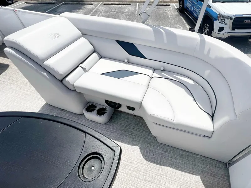 Slide: The Image of 2021 SunCatcher Select 20RC boat interior with white cushioned seating and cup holders. - 4