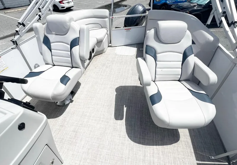 Slide: The Image of 2021 SunCatcher Select 20RC boat interior with plush white seating and modern design. - 5