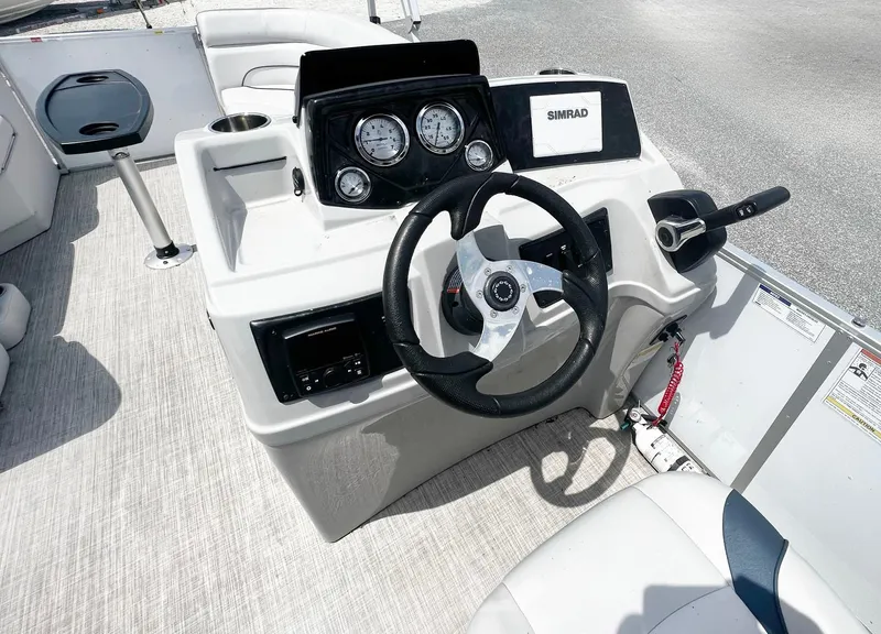 Slide: The Image of 2021 SunCatcher Select 20RC boat dashboard with steering wheel and gauges. - 6