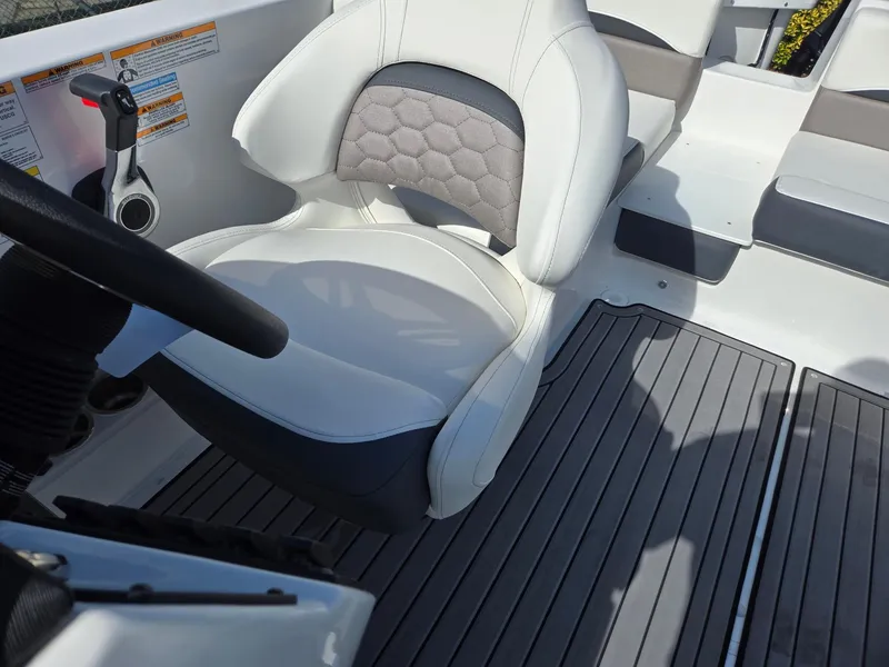 Slide: The Image of 2025 Hurricane SunDeck Sport 192 RL OB boat interior with cushioned seating and steering wheel. - 14