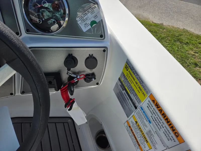 Slide: The Image of 2025 Hurricane SunDeck Sport 192 RL OB dashboard with controls and safety warnings. - 18