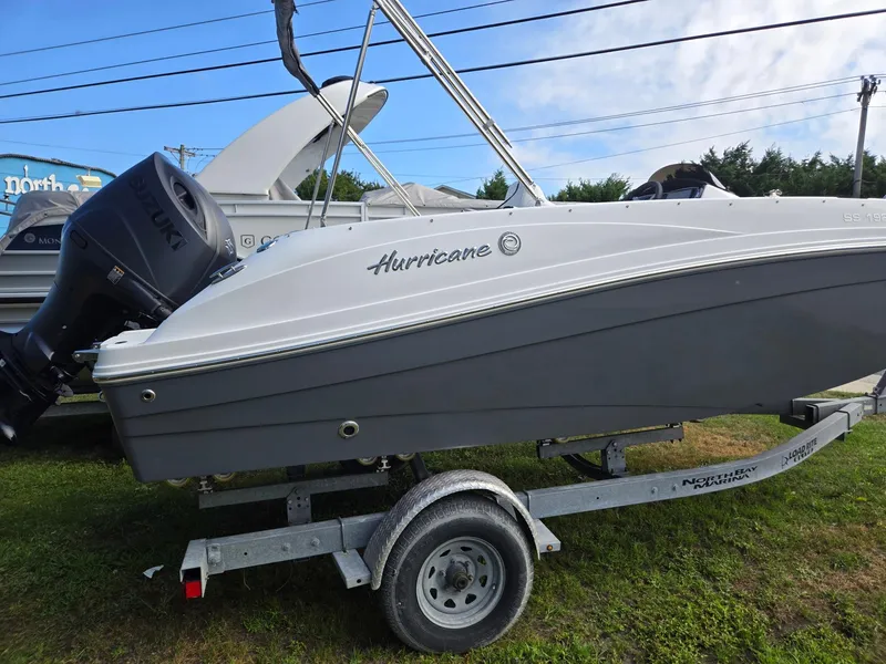 Slide: The Image of 2025 Hurricane SunDeck Sport 192 RL OB boat on trailer, side view. - 2