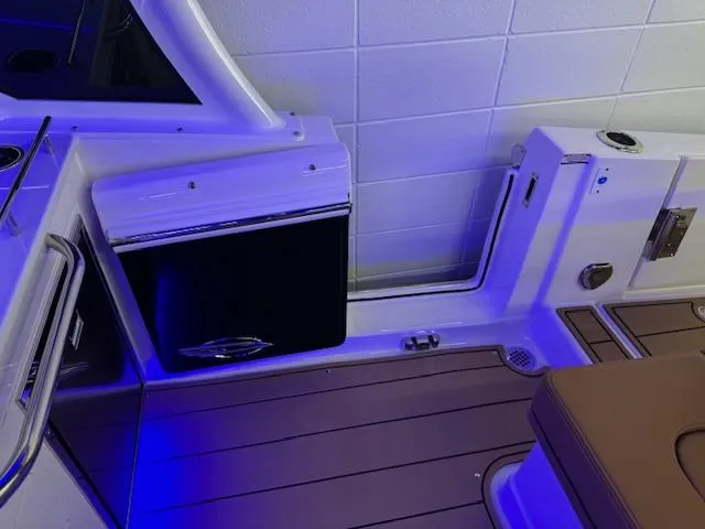 Slide: The Image of Interior of 2025 Chaparral 310 OSX boat with modern seating and ambient lighting. - 20
