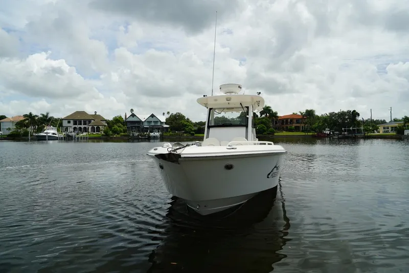 Slide: The Image of 2011 Everglades 295 boat on calm water with cloudy sky background. - 1