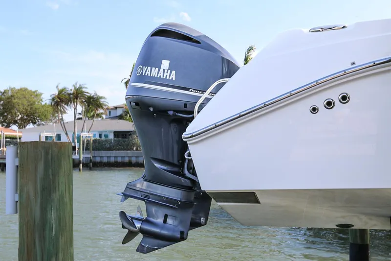 Slide: The Image of Everglades 295 boat with Yamaha outboard motor, docked by waterfront homes. - 11