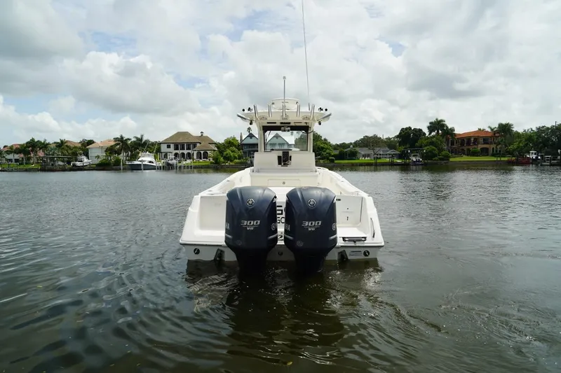 Slide: The Image of 2011 Everglades 295 boat with dual engines on a calm lake. - 12