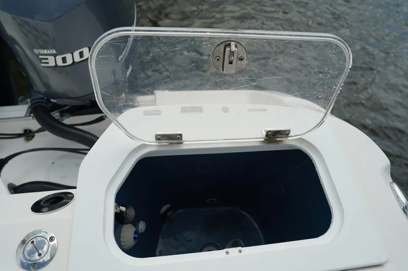 Slide: The Image of Open storage compartment on 2011 Everglades 295 boat with Yamaha 300 engine. - 14
