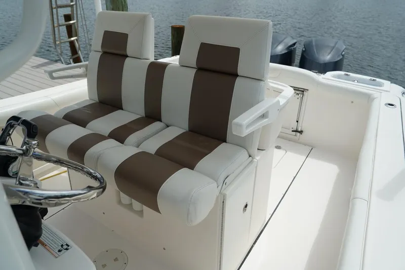Slide: The Image of 2011 Everglades 295 boat interior with striped seating and dual engines. - 17