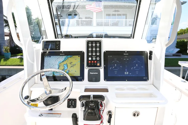 Slide: The Image of 2011 Everglades 295 boat dashboard with navigation screens and controls. - 18