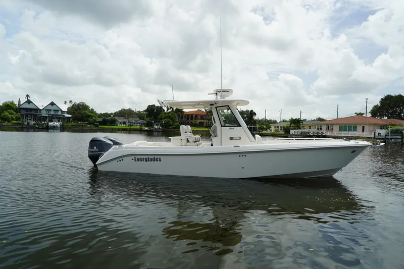 Slide: The Image of 2011 Everglades 295 boat on calm water, cloudy sky background. - 2