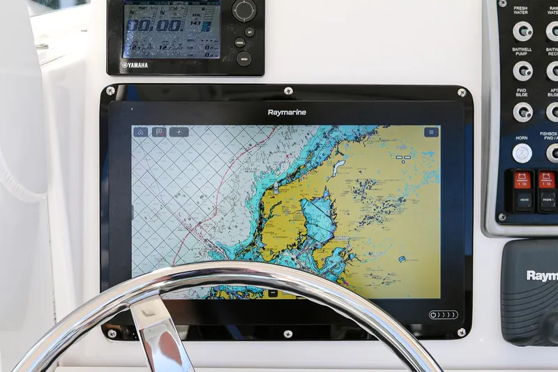 Slide: The Image of Raymarine navigation display on 2011 Everglades 295 boat dashboard with steering wheel. - 20