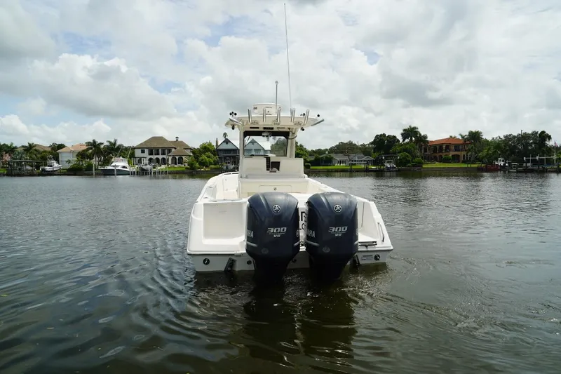 Slide: The Image of 2011 Everglades 295 boat with dual engines on a calm lake. - 3