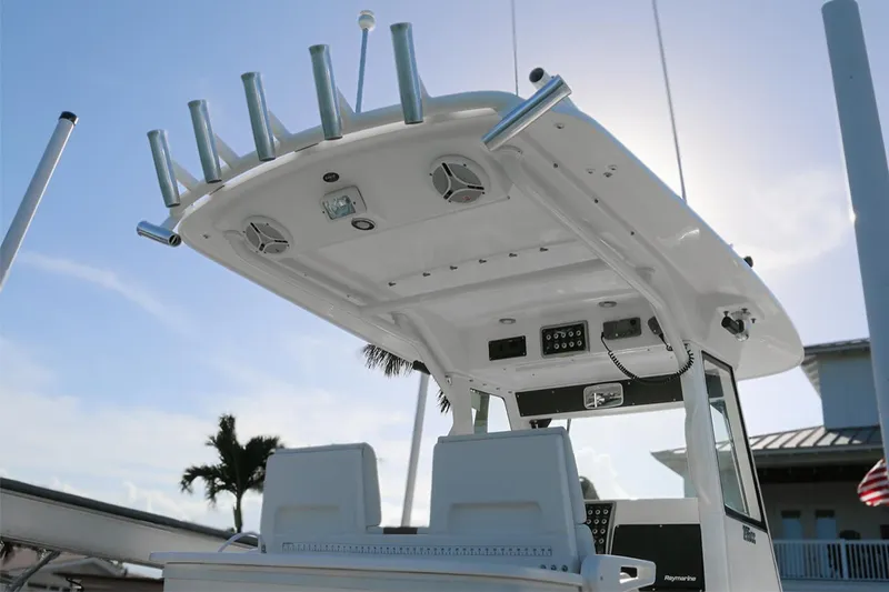 Slide: The Image of 2011 Everglades 295 boat with T-top and rod holders under a clear sky. - 32