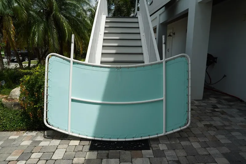 Slide: The Image of Boat windshield from a 2011 Everglades 295, displayed outdoors near stairs. - 33