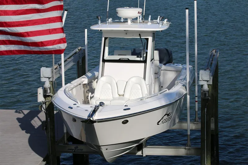 Slide: The Image of 2011 Everglades 295 boat docked, American flag, calm water background. - 34