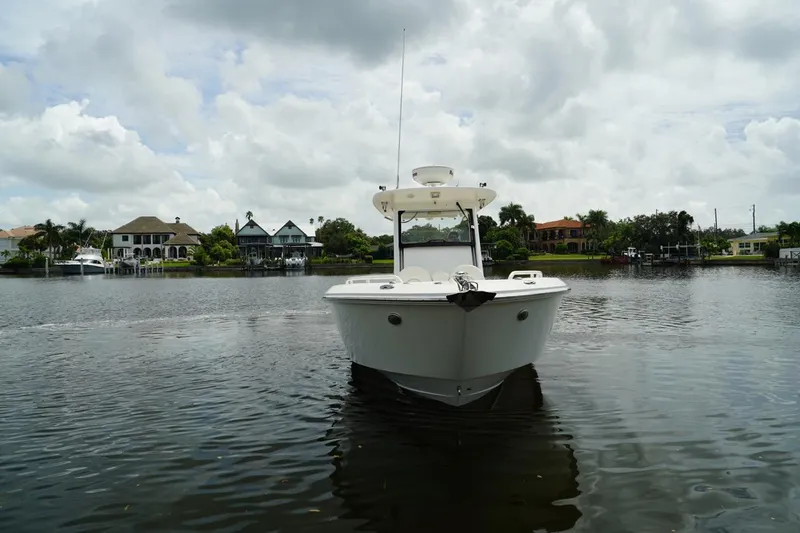 Slide: The Image of 2011 Everglades 295 boat on a calm lake with houses in the background. - 5