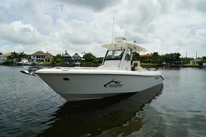 Slide: The Image of 2011 Everglades 295 boat on calm water with cloudy sky backdrop. - 6
