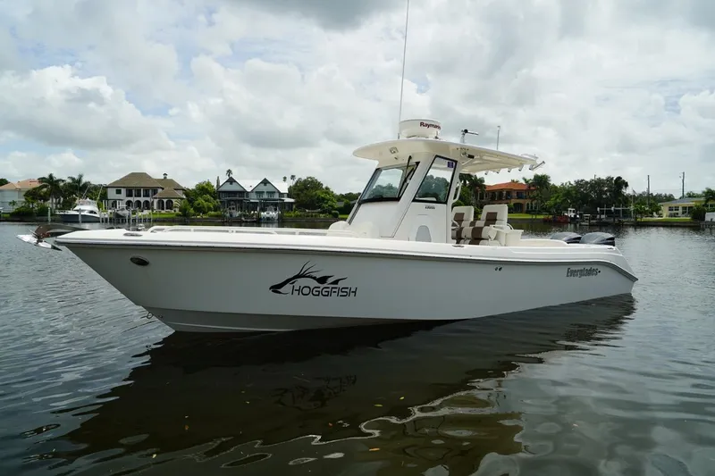 Slide: The Image of 2011 Everglades 295 boat on calm water, overcast sky, residential backdrop. - 7