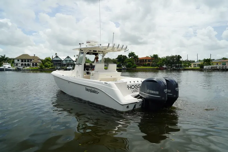 Slide: The Image of 2011 Everglades 295 boat on calm water with twin Yamaha engines. - 8