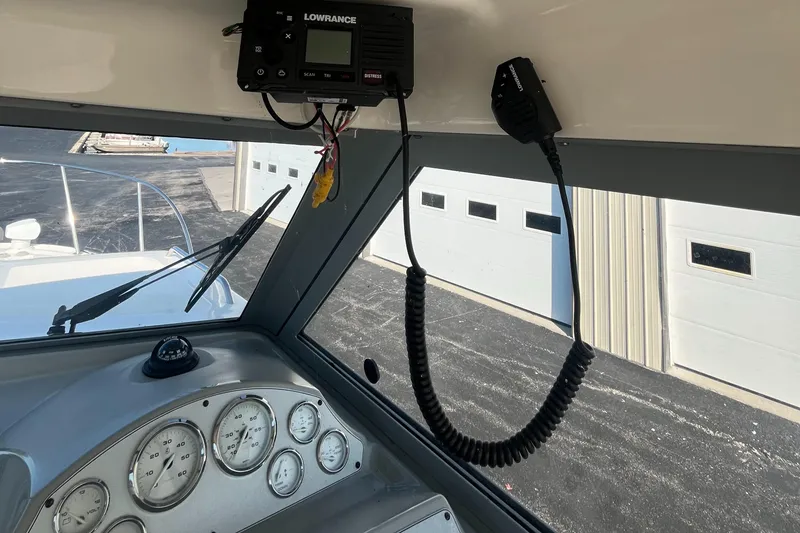 Slide: The Image of 2011 Bayliner 266 Discovery dashboard with gauges and Lowrance radio equipment. - 14