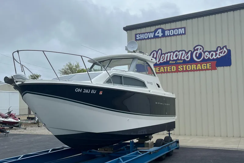 Slide: The Image of 2011 Bayliner 266 Discovery boat on trailer at Clemons Boats storage facility. - 2