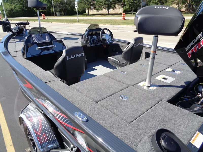 Slide: The Image of 2025 Lund 1875 Pro-V Bass XS boat interior with seating and storage compartments. - 10