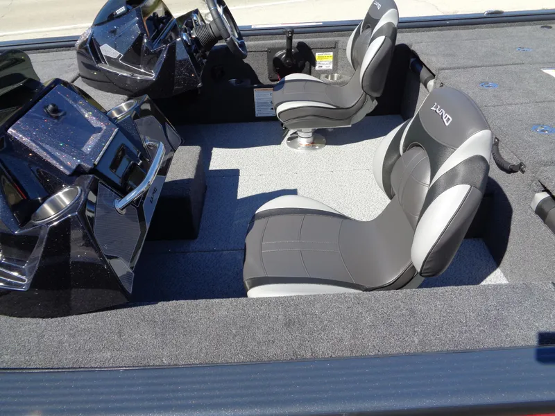 Slide: The Image of 2025 Lund 1875 Pro-V Bass XS boat interior with sleek seating and modern dashboard. - 12