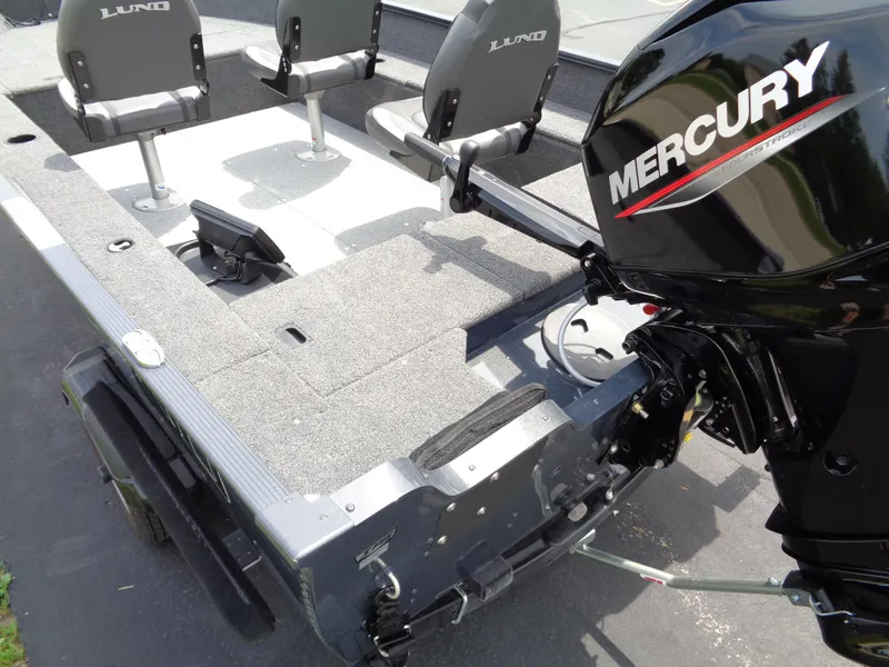 Slide: The Image of 2025 Lund 1875 Pro-V Bass XS boat with Mercury engine, featuring spacious seating and deck. - 13