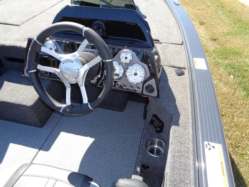 Slide: The Image of 2025 Lund 1875 Pro-V Bass XS boat dashboard with steering wheel and instrument panel. - 16
