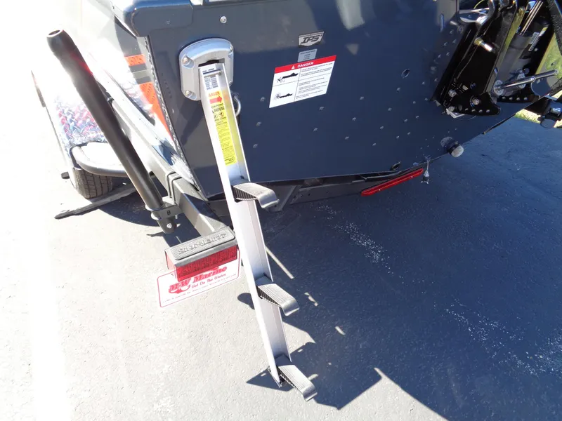 Slide: The Image of Rear view of 2025 Lund 1875 Pro-V Bass XS boat with ladder and safety labels. - 30