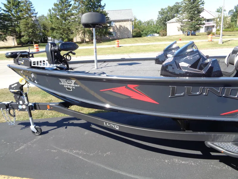 Slide: The Image of 2025 Lund 1875 Pro-V Bass XS boat on trailer, parked outdoors. - 6