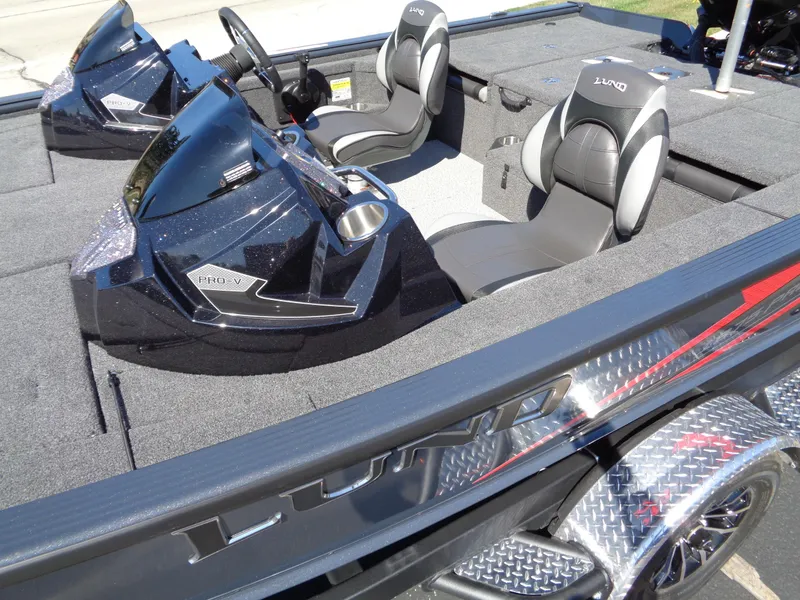 Slide: The Image of 2025 Lund 1875 Pro-V Bass XS boat interior with dual seats and sleek dashboard design. - 8