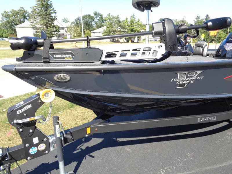 Slide: The Image of 2025 Lund 1875 Pro-V Bass XS boat on trailer, featuring Minn Kota trolling motor. - 9
