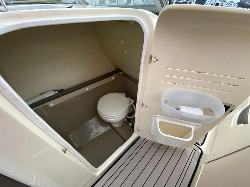 Slide: The Image of 2014 Yamaha Boats 242 Limited S interior with compact marine toilet. - 11