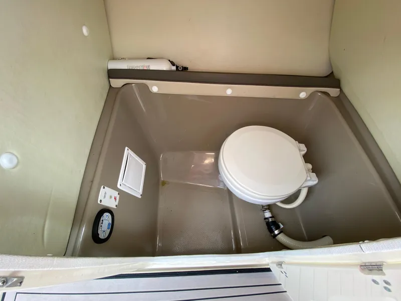 Slide: The Image of 2014 Yamaha Boats 242 Limited S interior with compact marine toilet. - 12