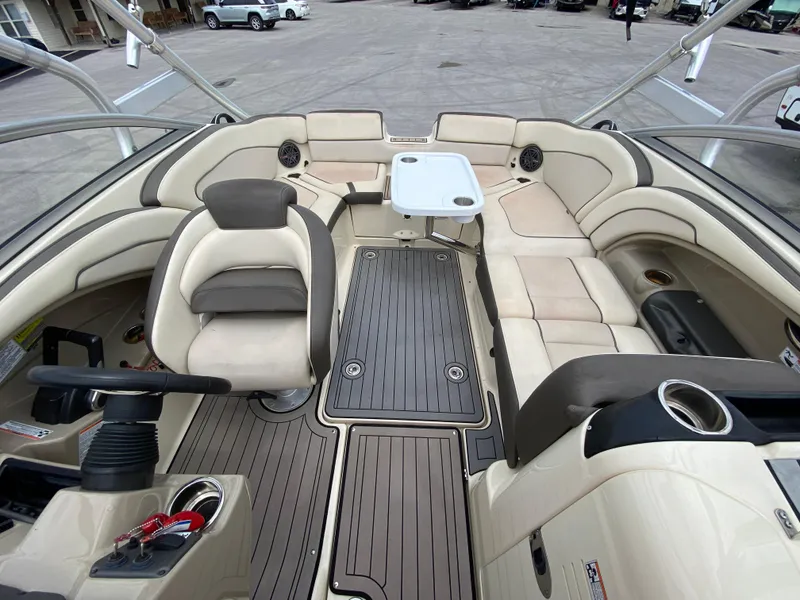 Slide: The Image of 2014 Yamaha Boats 242 Limited S interior with beige seating and a central table. - 14