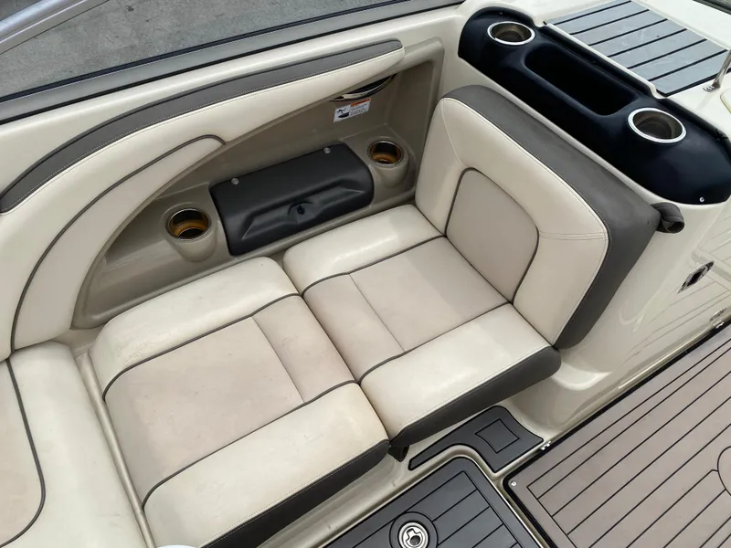 Slide: The Image of 2014 Yamaha Boats 242 Limited S interior seating with cup holders and storage. - 15